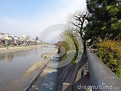 Riverside, a pedestrian walk between river and greenery Stock Photo