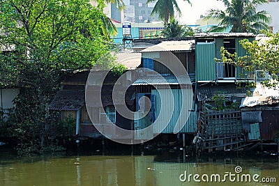 Riverside slum, houses near polluted river Editorial Stock Photo