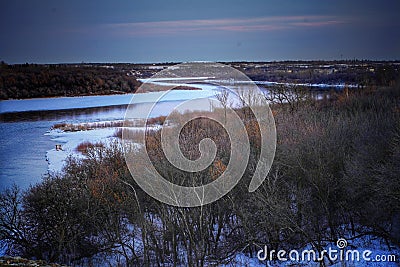 Riverside winter river sky ice blue landscape snow frozen cold forest Stock Photo