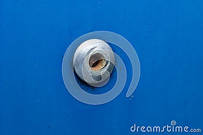 rivet on a blue metal background Stock Photo