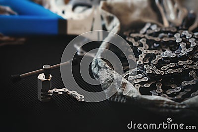 Riveting tool with old dirty bicycle chain. Stock Photo