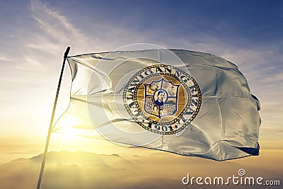 Rizal province of Philippines flag textile cloth fabric waving on the top sunrise mist fog Stock Photo