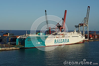 Ro-Ro, passenger ship operated by the Spanish company BALEARIA moored in Barcelona during loading cars and lories. Editorial Stock Photo