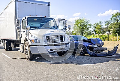 Road accident with damage to vehicles as a result of a collision between a semi truck with box trailer and a car Stock Photo