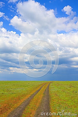 Road across meadow Stock Photo