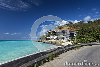Road along a beach at Antigua island in the Caribbean Stock Photo