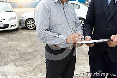 On the road car accident insurance agent examining carcrash Stock Photo