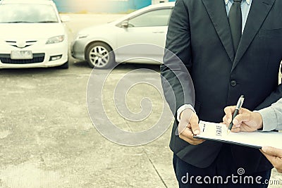 On the road car accident insurance agent examining carcrash Stock Photo