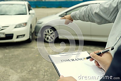 On the road car accident insurance agent examining carcrash Stock Photo