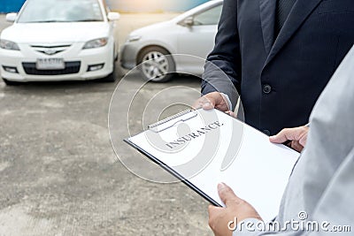 On the road car accident insurance agent examining carcrash Stock Photo
