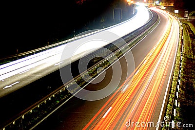 Road with car traffic at night with blurry lights Stock Photo