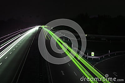 Road with car traffic at night with blurry lights Stock Photo