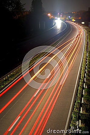 Road with car traffic at night with blurry lights Stock Photo