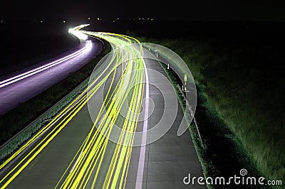 Road with car traffic at night with blurry lights Stock Photo