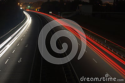 Road with car traffic at night with blurry lights Stock Photo