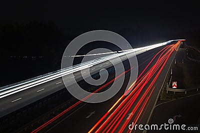 Road with car traffic at night with blurry lights Stock Photo