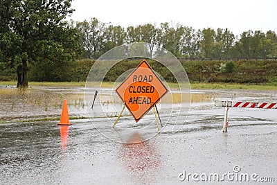 Road Closed Sign Warning of Rain Flooded Road Stock Photo