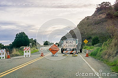 `Road closed ` and `Slide Ahead ` signs Stock Photo