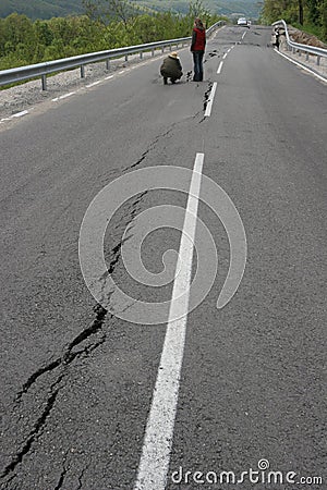 Road collapses with huge cracks. International road collapsed down after bad construction. Damaged Highway Road. Asphalt road. Editorial Stock Photo