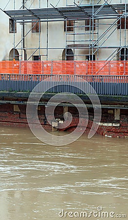 road construction site t to reinforce the river embankment in full flood Stock Photo