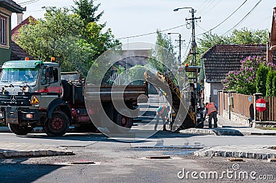 Road construction workers cleaning the street Editorial Stock Photo