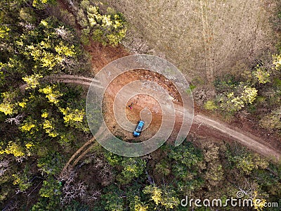 Road crossroad tree nature aerial field green rural country dirt top drone forest view car high through meadow above route trail Stock Photo