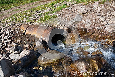 Culvert was washed away by the waters of stream Stock Photo