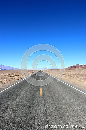 Road in the Death Valley National Park with colorful sky background, California Stock Photo