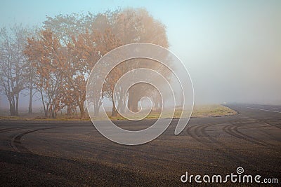 The road in the early misty autumn morning Stock Photo