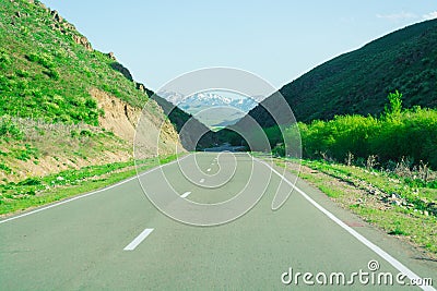 Road. Edge. Green Hill. Clear day. Mountains `Alatau` Stock Photo