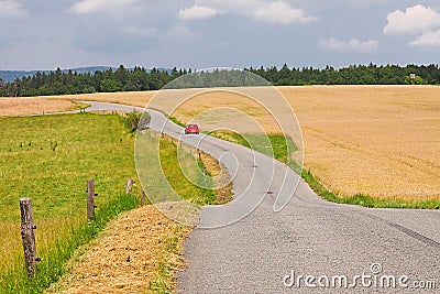 Road through farmlands Stock Photo
