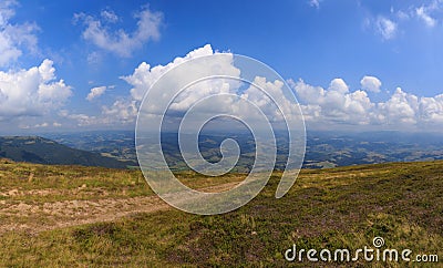 Road on grass on the hill on mountain background Stock Photo