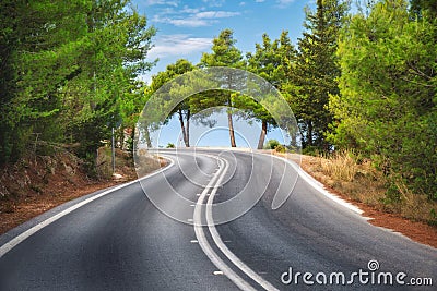 Road in green forest at sunset in summer. Empty mountain road Stock Photo