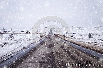 Road during heavy snowstorm blizzard in winter. Dangerous driving conditions Stock Photo