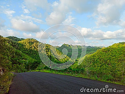 Road, Hill, and Blue Skies Stock Photo