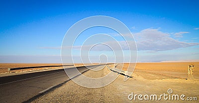 A Road into the horizon, the door to Sahara Desert, Douz, Tunisia Stock Photo