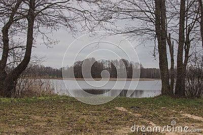 The road by the lake on a cloudy rainy day Stock Photo