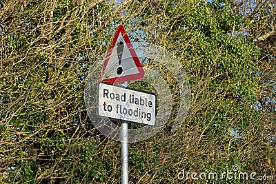 Road Liable to flooding. Metal Warning sign Stock Photo