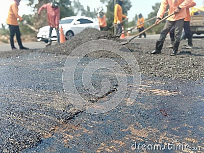 Road maintenance work using human labor Stock Photo