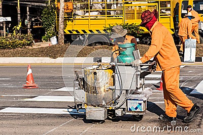 Road Marking Workers at Work Under Scorching Sun. Editorial Stock Photo