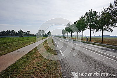 Road network in Netherlands, high quality roads in countryside, landscape with fields, road and bicycle line Stock Photo