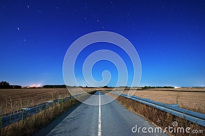 Road at night under moonlight Stock Photo