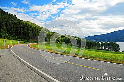 Mountains road sky landscape mountain summer travel empty highway nature asphalt green forest rural way blue beautiful trip route Stock Photo