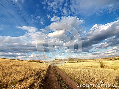 Road over yellow hills Stock Photo