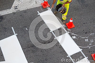Road painter worker working on zebra crossing Stock Photo