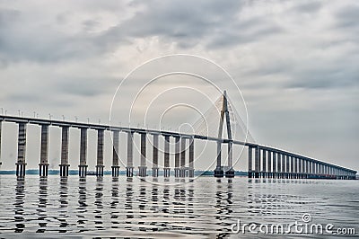 Road passage over water on cloudy sky. Bridge over sea in manaus, brazil. architecture and design concept. Travel destination and Stock Photo