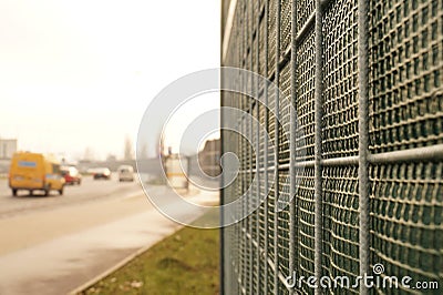 Close-up on the construction. The road is protected against noise emission by noise-absorbing barrier also called a noise wall, Stock Photo