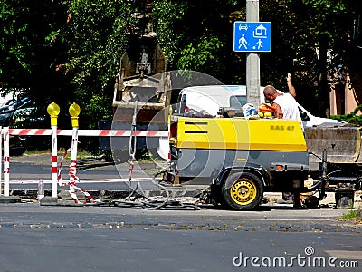road repair and excavation by hydraulic machine installing drain pipes Editorial Stock Photo