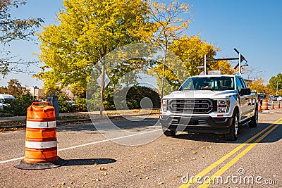 Road repair sign signal lights are flashing and detour on a service truck. Traffic directional light on a truck Stock Photo