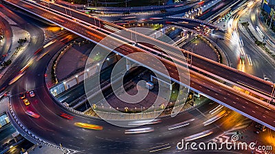Road roundabout intersection in the city at night with vehicle car light movement, Aerial view Stock Photo